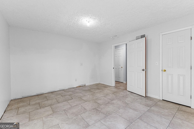 unfurnished bedroom featuring visible vents and a textured ceiling