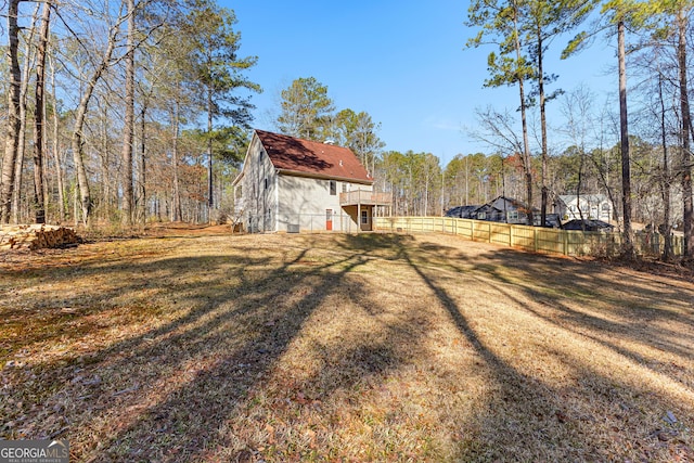 view of yard featuring fence and a view of trees