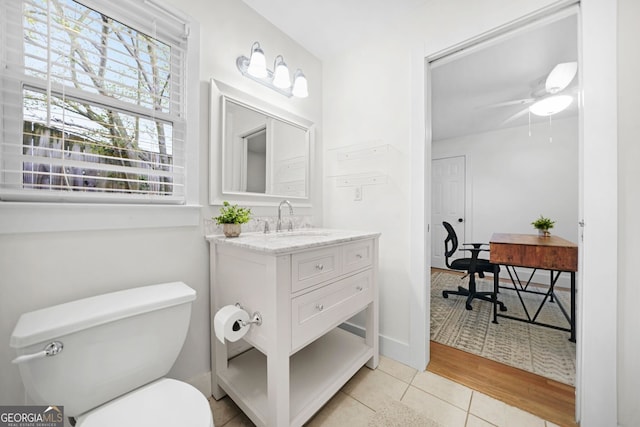 bathroom with tile patterned floors, a ceiling fan, toilet, and vanity