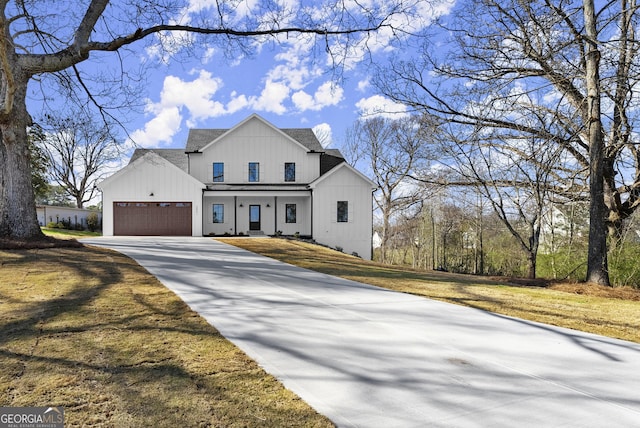 modern inspired farmhouse featuring driveway, roof with shingles, a front lawn, a garage, and board and batten siding