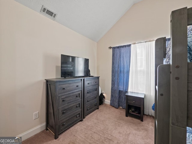 bedroom featuring visible vents, light carpet, baseboards, and vaulted ceiling