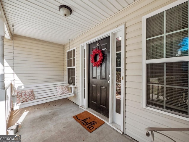 view of exterior entry with a porch