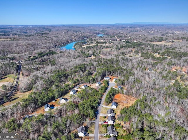 drone / aerial view featuring a forest view