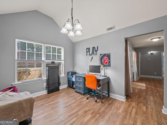 office area featuring visible vents, wood finished floors, an inviting chandelier, baseboards, and vaulted ceiling