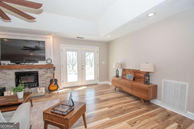 interior space with visible vents, baseboards, wood finished floors, and french doors