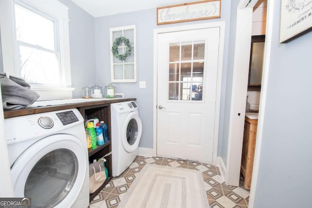 clothes washing area featuring washer and dryer, baseboards, laundry area, and light tile patterned floors