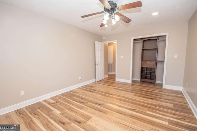 unfurnished bedroom with a ceiling fan, recessed lighting, a closet, light wood finished floors, and baseboards