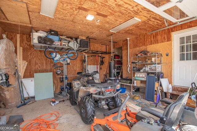 garage featuring wood walls and a workshop area