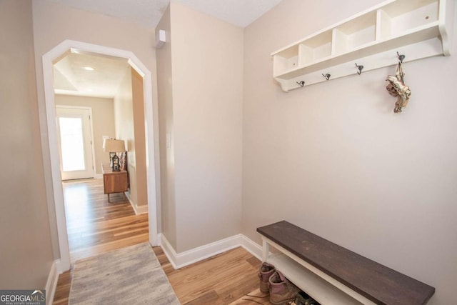 mudroom with baseboards and light wood-style flooring