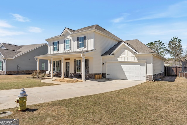 traditional-style home featuring board and batten siding, a front lawn, a porch, concrete driveway, and a garage