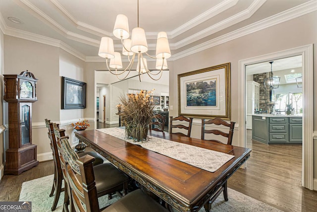 912 Mcelroy Mountain Dr, Big Canoe, GA 30143 - dining room featuring a tray ceiling, a chandelier, wood finished floors, and ornamental molding