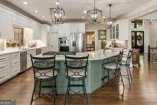 912 Mcelroy Mountain Dr, Big Canoe, GA 30143 - kitchen with stainless steel appliances, decorative backsplash, a large island, white cabinetry, and recessed lighting
