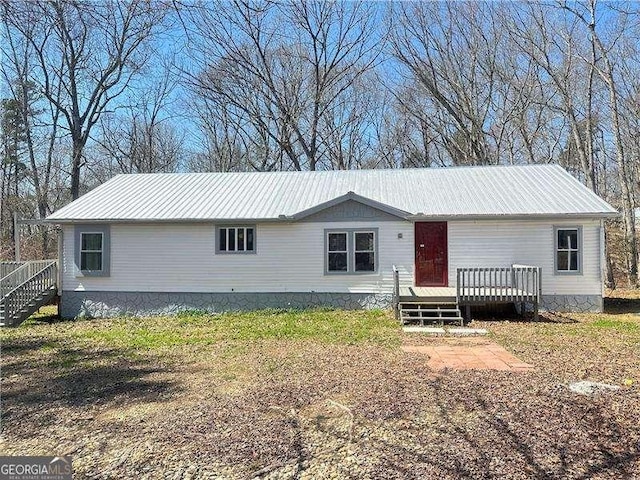 view of front of property with metal roof and a wooden deck