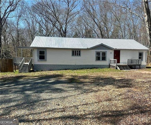 view of front of home featuring a deck and metal roof