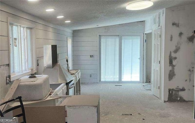 dining space featuring lofted ceiling and a textured ceiling