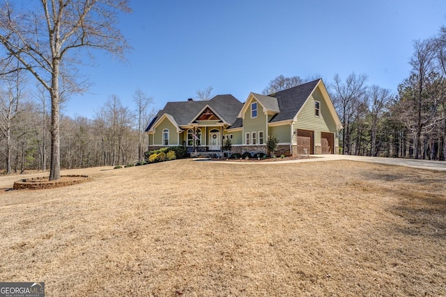 craftsman house with a front lawn, driveway, and a chimney