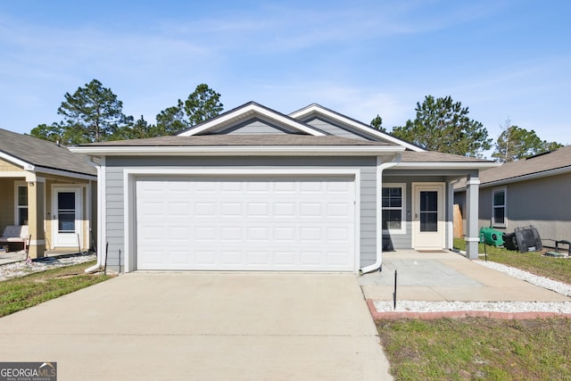 ranch-style home with concrete driveway and a garage