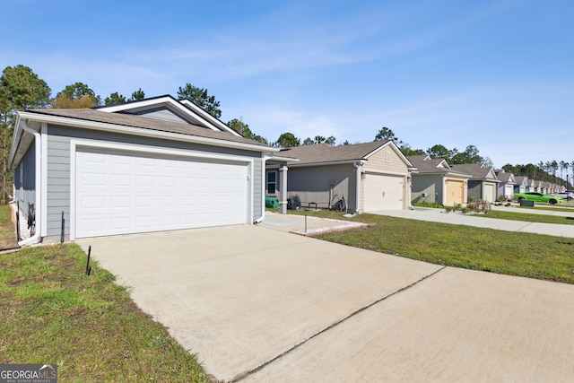 single story home with a residential view, a detached garage, and a front yard