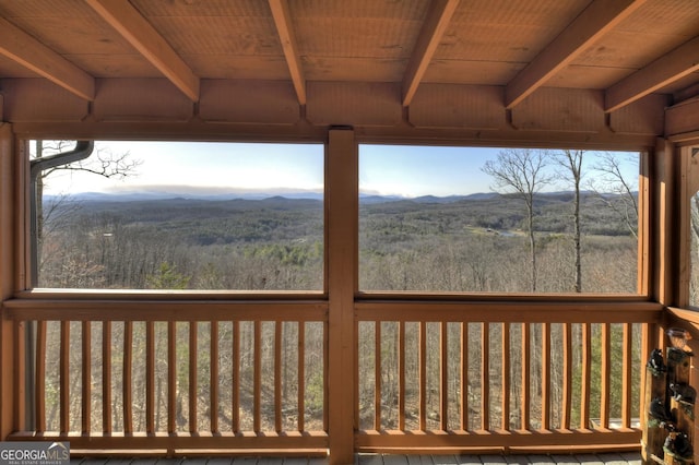 wooden terrace featuring a forest view and a mountain view