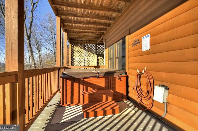 wooden terrace featuring a hot tub