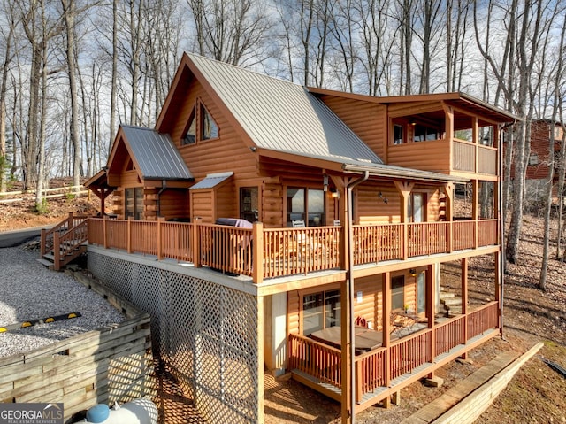 exterior space featuring a deck and metal roof