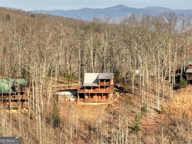 drone / aerial view with a mountain view and a view of trees