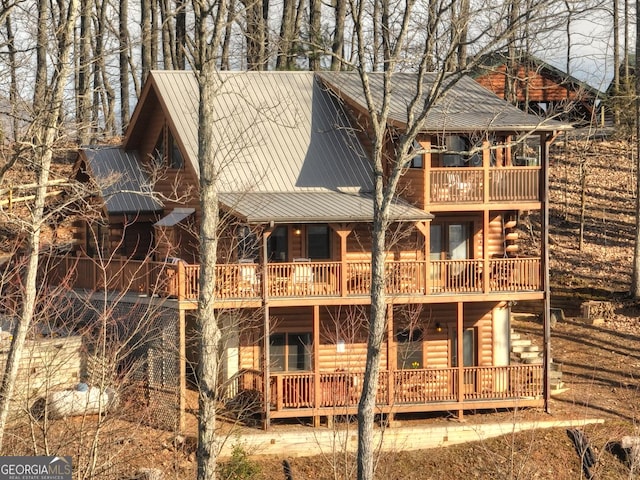 rear view of house featuring metal roof