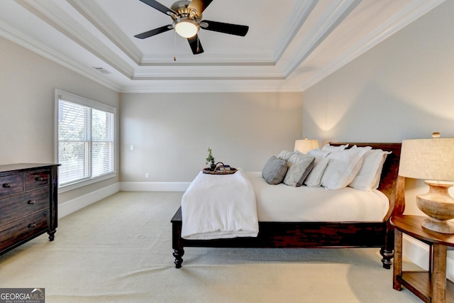 bedroom featuring baseboards, carpet floors, visible vents, crown molding, and a raised ceiling