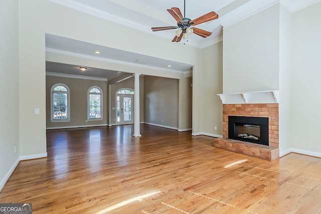 1621 Annapolis Way, Grayson, GA 30017 - unfurnished living room with wood finished floors, a fireplace, crown molding, baseboards, and ceiling fan