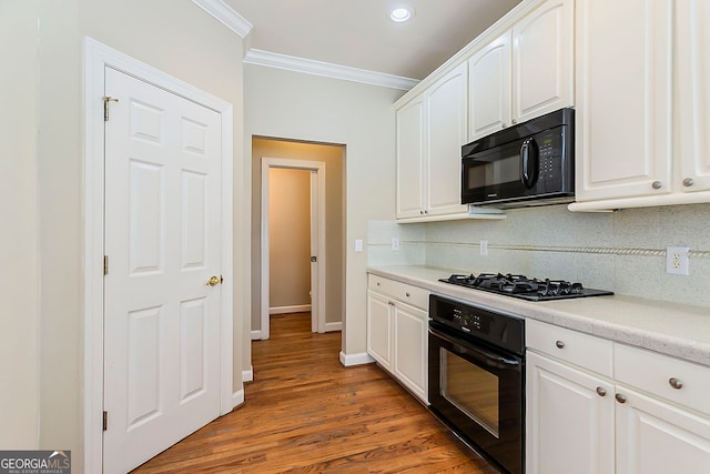 1621 Annapolis Way, Grayson, GA 30017 - kitchen featuring tasteful backsplash, white cabinetry, black appliances, and ornamental molding