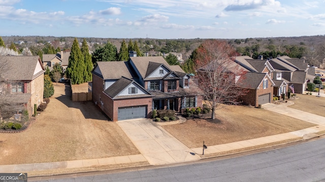 view of front of home featuring a residential view, an attached garage, and driveway