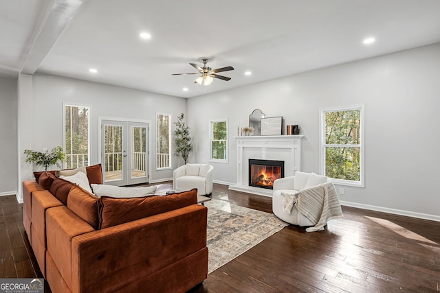 living area featuring a glass covered fireplace, recessed lighting, french doors, and dark wood-style flooring