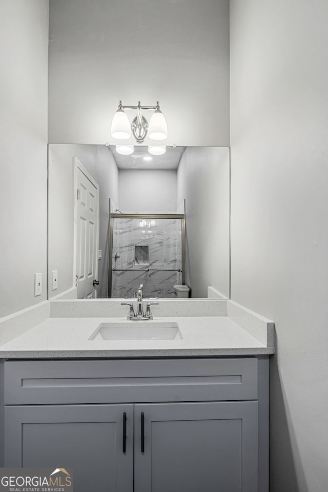 full bathroom with vanity and a stall shower