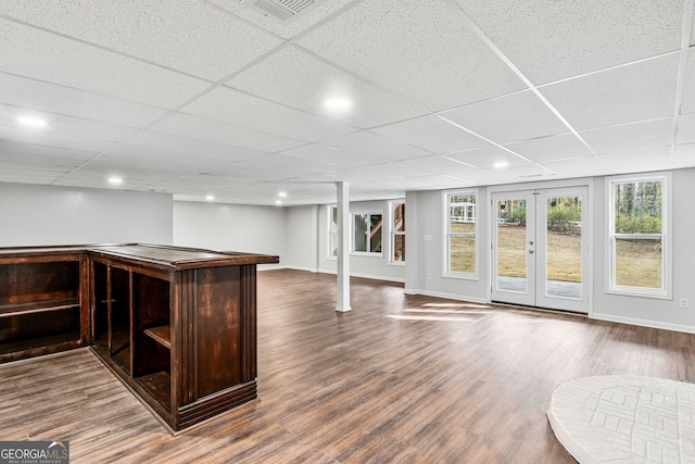 bar with dark wood-style floors, french doors, a paneled ceiling, and baseboards