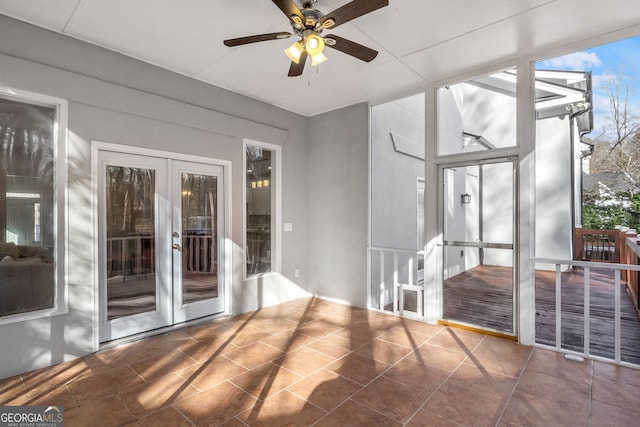 unfurnished sunroom featuring french doors and a ceiling fan