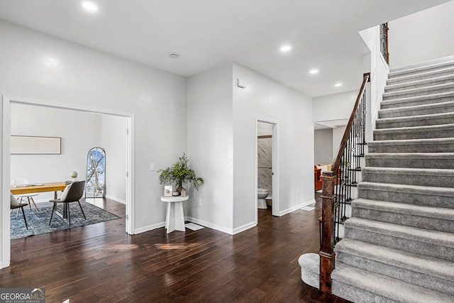 foyer entrance with recessed lighting, baseboards, hardwood / wood-style floors, and stairs