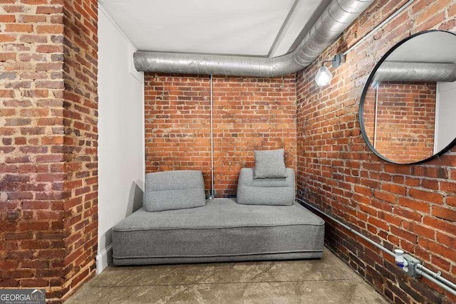 living area with brick wall