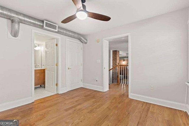 unfurnished bedroom featuring visible vents, baseboards, light wood-style flooring, and a ceiling fan