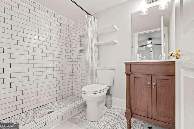 bathroom with a tile shower, tile patterned floors, toilet, and vanity