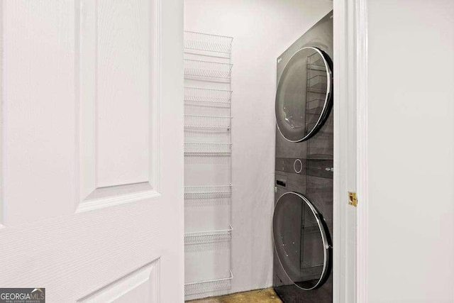 laundry area featuring laundry area and stacked washer and dryer