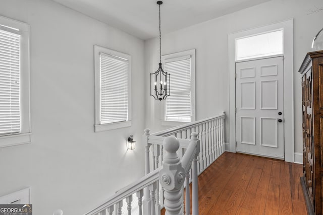 entrance foyer with a notable chandelier and wood finished floors