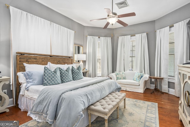 bedroom with visible vents, a ceiling fan, and wood finished floors