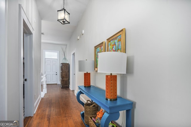 hallway with baseboards and wood-type flooring