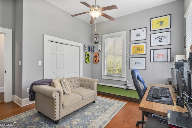 office area with baseboards, a ceiling fan, and wood finished floors