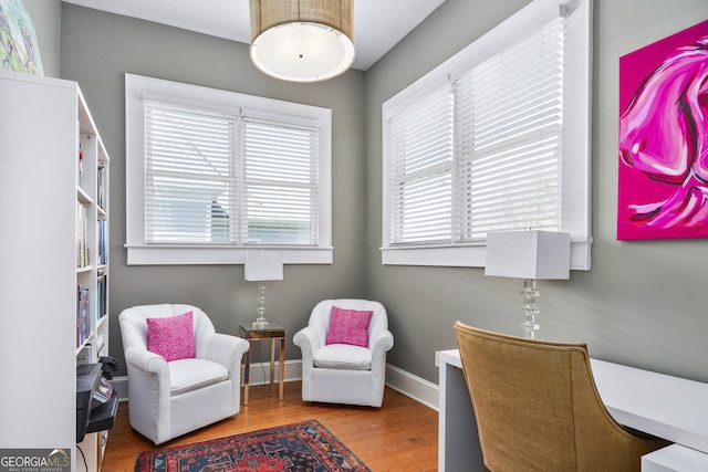 living area featuring wood finished floors and baseboards