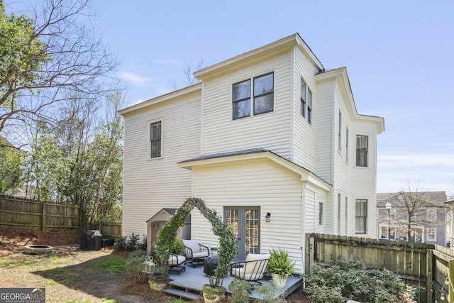 rear view of property with fence