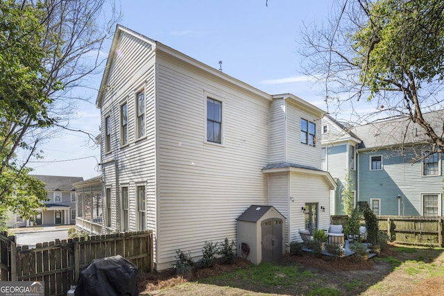 rear view of property with fence