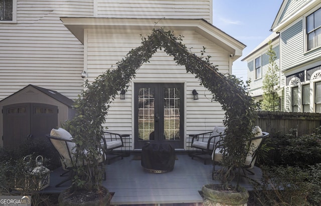 exterior space with french doors, a deck, and fence