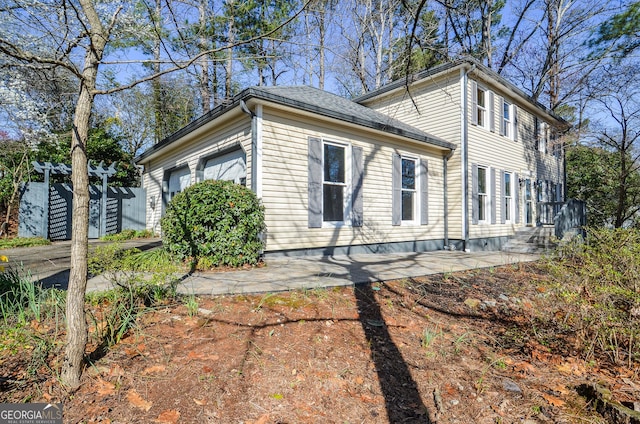 view of side of home featuring a garage