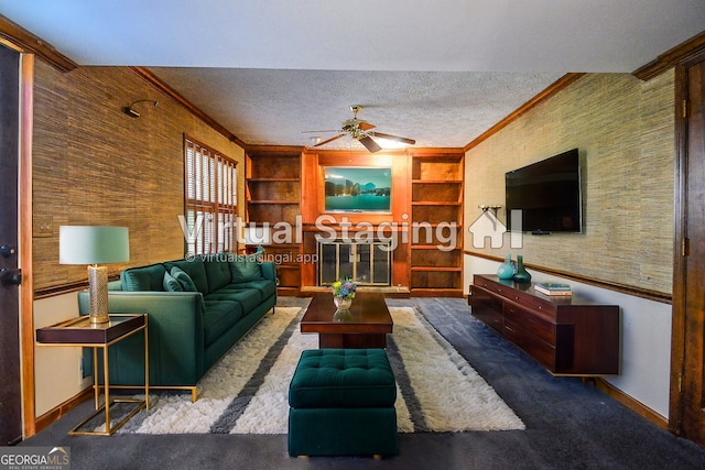 living room with built in features, a textured ceiling, crown molding, and a ceiling fan